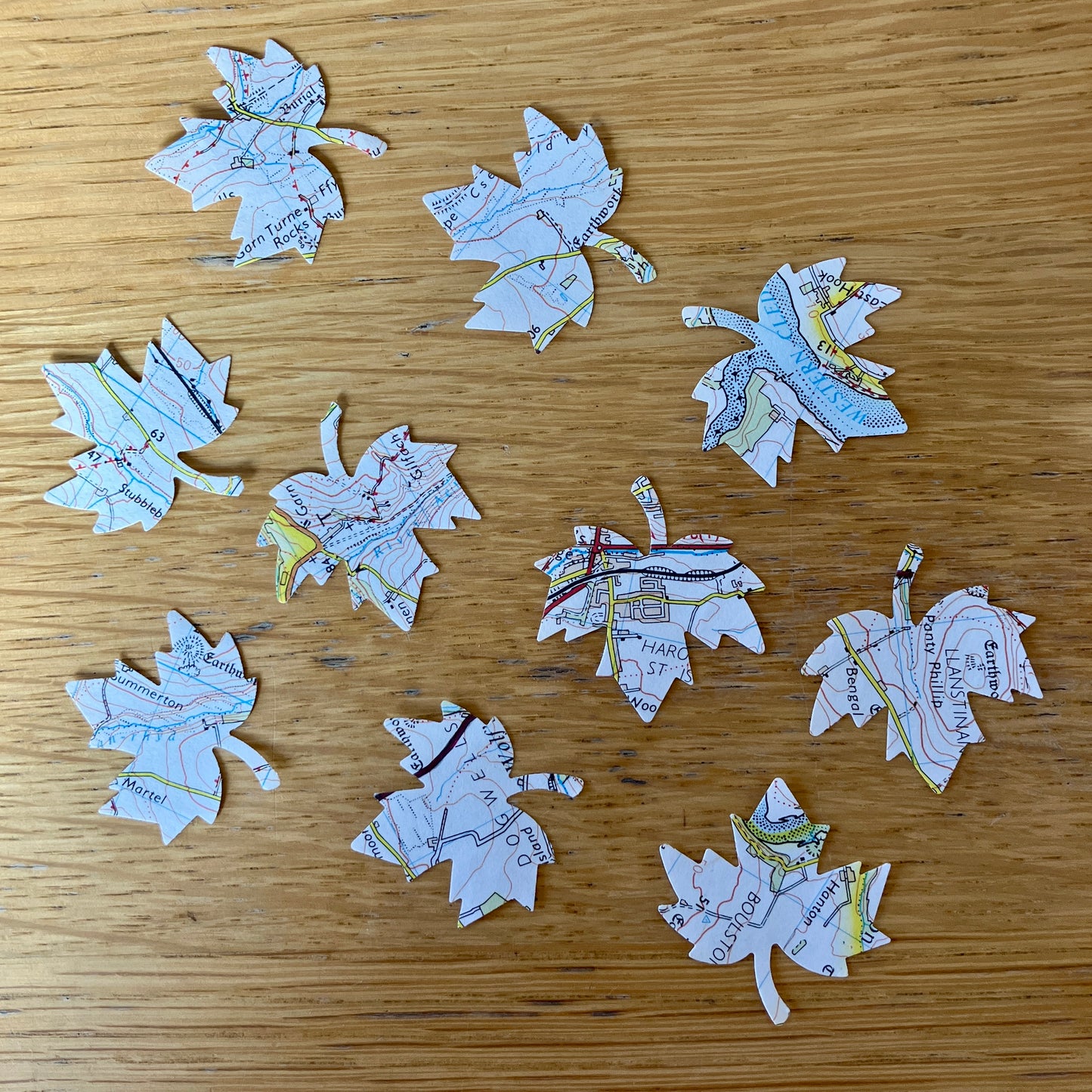 50 die cut leaf embellishments on recycled map paper from Wales