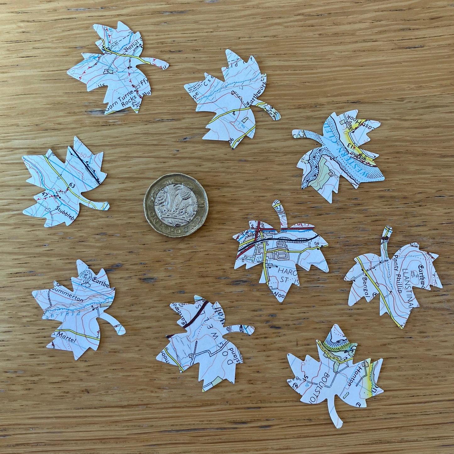 50 die cut leaf embellishments on recycled map paper from Wales